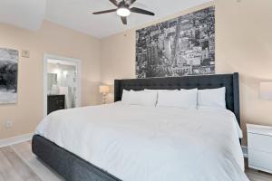 een slaapkamer met een groot wit bed en een plafondventilator bij FL King Velvet Suite- 3bdrm/2Bath-2000 sq ft in Orlando