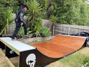 a boy is riding a skateboard on a ramp at Beachside Weekender Retreat with Spa sleeps 11-13 in Ocean Grove