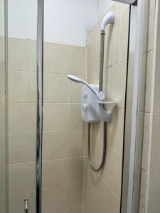 a shower in a bathroom with a shower head at Flat in Cheam in Sutton