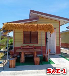 a small yellow caravan with a picnic table and benches at S&E-1 Tiny Guest House - Olango Island in Lapu Lapu City
