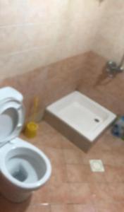 a bathroom with a white toilet and a sink at استوديو in Sharjah