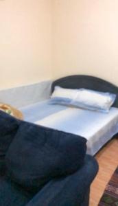 a bed and a couch in a room at استوديو in Sharjah