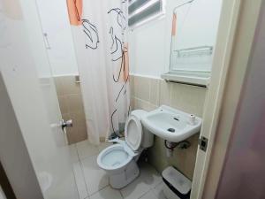 a small bathroom with a toilet and a sink at S&E-1 Tiny Guest House - Olango Island in Lapu Lapu City