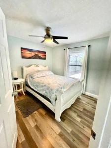 a bedroom with a bed and a ceiling fan at Heated Pool home fenced yard near the beach in Palm Coast +29 photos