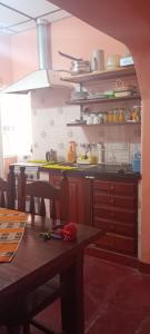 a kitchen with a table and a counter top at Casa Aires del hornocal in Humahuaca