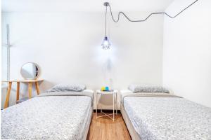 Postel nebo postele na pokoji v ubytování Snooze Hotel