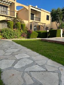a stone walkway in front of a house at Ermis Sunset in Paphos