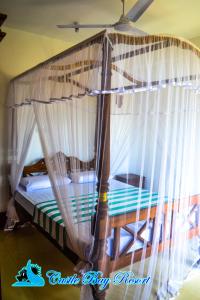 a bed with a canopy in a room at Castle Bay Resort in Weligama