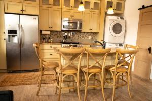a kitchen with a table with chairs and a refrigerator at Ranch at Mesa Verde in Cortez