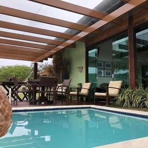 a swimming pool in front of a house with a patio at Monte Castelo in Bezerros +14 photos