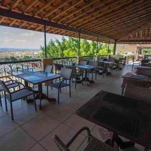 a restaurant with tables and chairs and a view of the city at Monte Castelo in Bezerros +14 photos