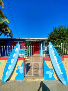 a couple of surfboards on display in front of a gate at Pequi hostel in Florianópolis