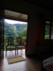 an open door to a room with a view of a mountain at Super View in Ella