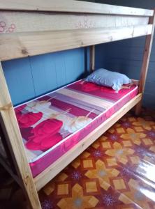 a bunk bed in a room with flowers on it at Casas Salomão in Santo António