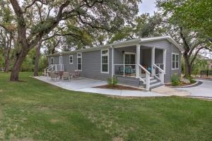 a tiny house with a porch and a yard at Arete Stay in Austin