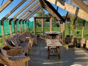 a pavilion with couches and a table and a table sidx sidx at Willow Cottage Retreat in Brightwater +3 photos