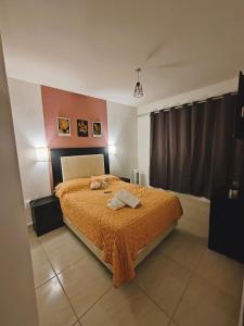 a bedroom with a bed with two towels on it at Casa Real San Marcos B en Privada Zona Norte in Irapuato