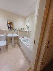 ein Badezimmer mit einer Badewanne, einem Waschbecken und einem WC in der Unterkunft Modern 2BR Chester Flat in Chester