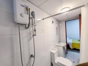 a bathroom with a shower and a toilet and a sink at SANTA VICTORIA HOUSE in Chiclayo