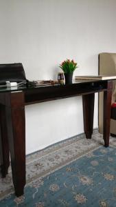 a wooden desk in a room with a plant on it at One Mek Homestay in Bachok