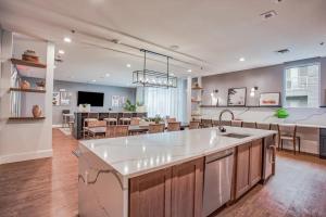 a kitchen and living room with a large white counter top at Ft Worth 1BR Luxury Retreat in Fort Worth