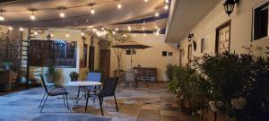a patio with a table and chairs and lights at Doña Adelina House in Ciudad Valles