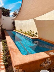 a swimming pool in the backyard of a house at Casa Libertad Tepic in Tepic