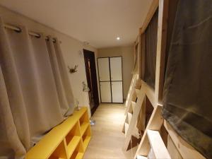 a room with wooden shelves and a hallway with a door at Seoul Papa Guesthouse 외국인전용 in Seoul