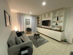 a living room with a couch and a television at Casa VARI in Morelia
