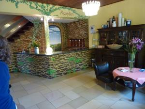 a room with a table and a stone wall at Hotel Oranien in Nastätten