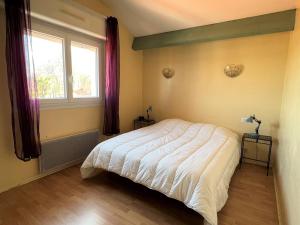 a bedroom with a bed and a window at Charmant T2 au calme avec terrasse, parking et accès internet à Cambo-les-Bains - FR-1-495-11 in Cambo-les-Bains