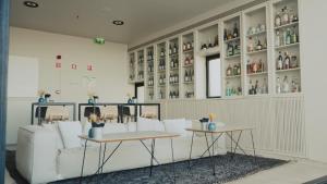 a room with couches and tables and shelves at Memmo Alfama - Design Hotels in Lisbon