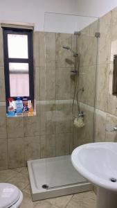 a bathroom with a shower and a sink at apartment in the city center in Durrës