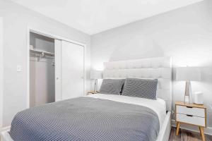 a white bedroom with a large bed and a window at Mazor Luxury Two Bedroom Vacation Home in Fort Lauderdale