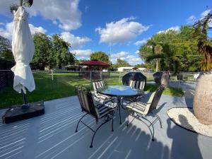 a patio with a table and chairs on a deck at Rachaels Upscale 3 Bedrooms Luxury Home in Fort Lauderdale