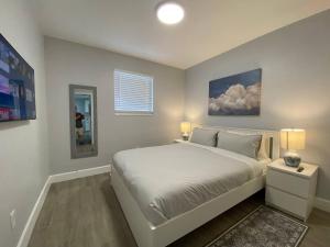 フォート・ローダーデールにあるRachaels Upscale 3 Bedrooms Luxury Homeの大きな白いベッドと鏡のある寝室
