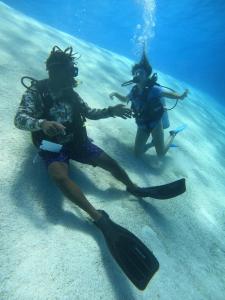 two people in the water in the ocean at Posada In the Caribbean in Providencia