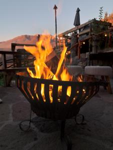 a fire pit with flames in it on a patio at Hostal Boutique CUMBRES in Farellones