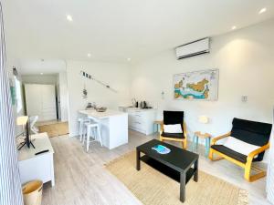 un salon avec un canapé et une table dans l'établissement Sailor's Cottage - Stay Waiheke, à Blackpool 5 autres photos