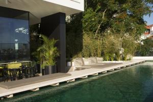 an external view of a house with a swimming pool at Memmo Príncipe Real, a Member of Design Hotels in Lisbon