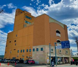 a large brick building with cars parked in front of it at Hotel Royal Kitami - Vacation STAY 04905v in Kitami
