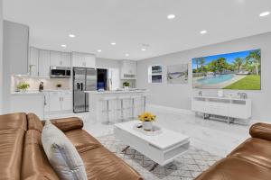 a living room with a couch and a table at Yehudas Tropical Villa with Heated Infinity Pool in Hollywood