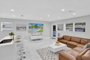 a living room with a couch and a table at Yehudas Tropical Villa with Heated Infinity Pool in Hollywood