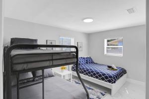 a bedroom with two bunk beds and a bed at Yehudas Tropical Villa with Heated Infinity Pool in Hollywood +35 photos