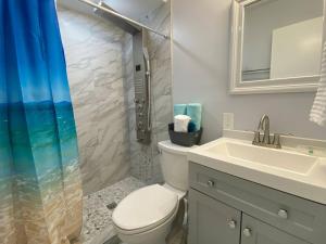 a bathroom with a toilet and a sink and a shower at Mazor Luxury Three Bedrooms Vacation Home in Fort Lauderdale