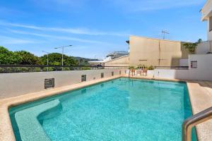 a swimming pool on top of a building at 604 Chic City Apartment with Water Views in Cairns
