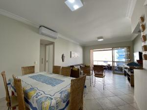 a dining room with a table and chairs in a room at Riviera de Sao Lourenço in Bertioga