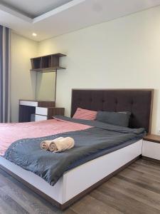 a bedroom with a bed with two towels on it at Hi-Home - City view apartment in HongKong Tower in Hanoi