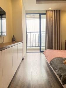 a bedroom with a bed and a large window at Hi-Home - City view apartment in HongKong Tower in Hanoi