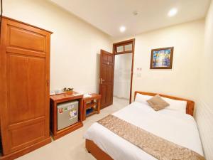 Postel nebo postele na pokoji v ubytování Hotel Phạm Duy